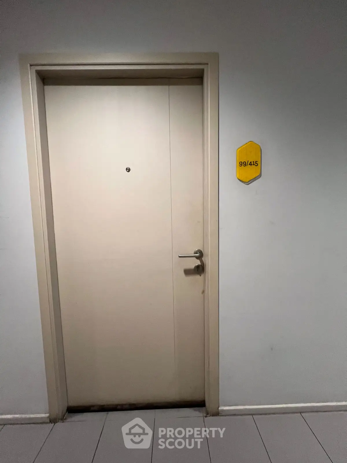 Modern apartment entrance with sleek door and room number sign, ideal for urban living.