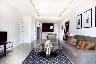 Spacious modern living room with elegant decor and open kitchen layout.