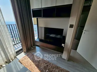 Modern living room with balcony view and sleek entertainment center