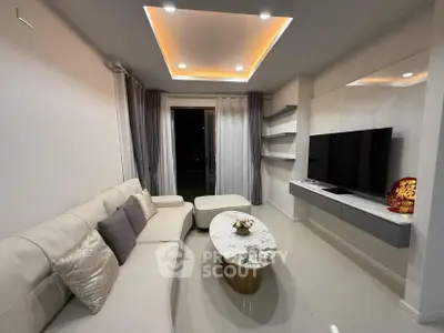 Modern living room with stylish ceiling lights and sleek furniture design.