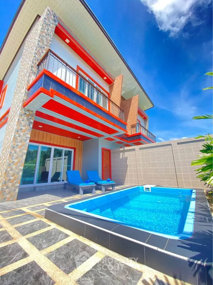 Stunning modern villa with private pool and spacious balcony under clear blue skies.
