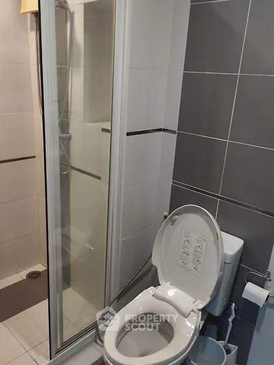 Modern bathroom with shower and toilet in sleek design