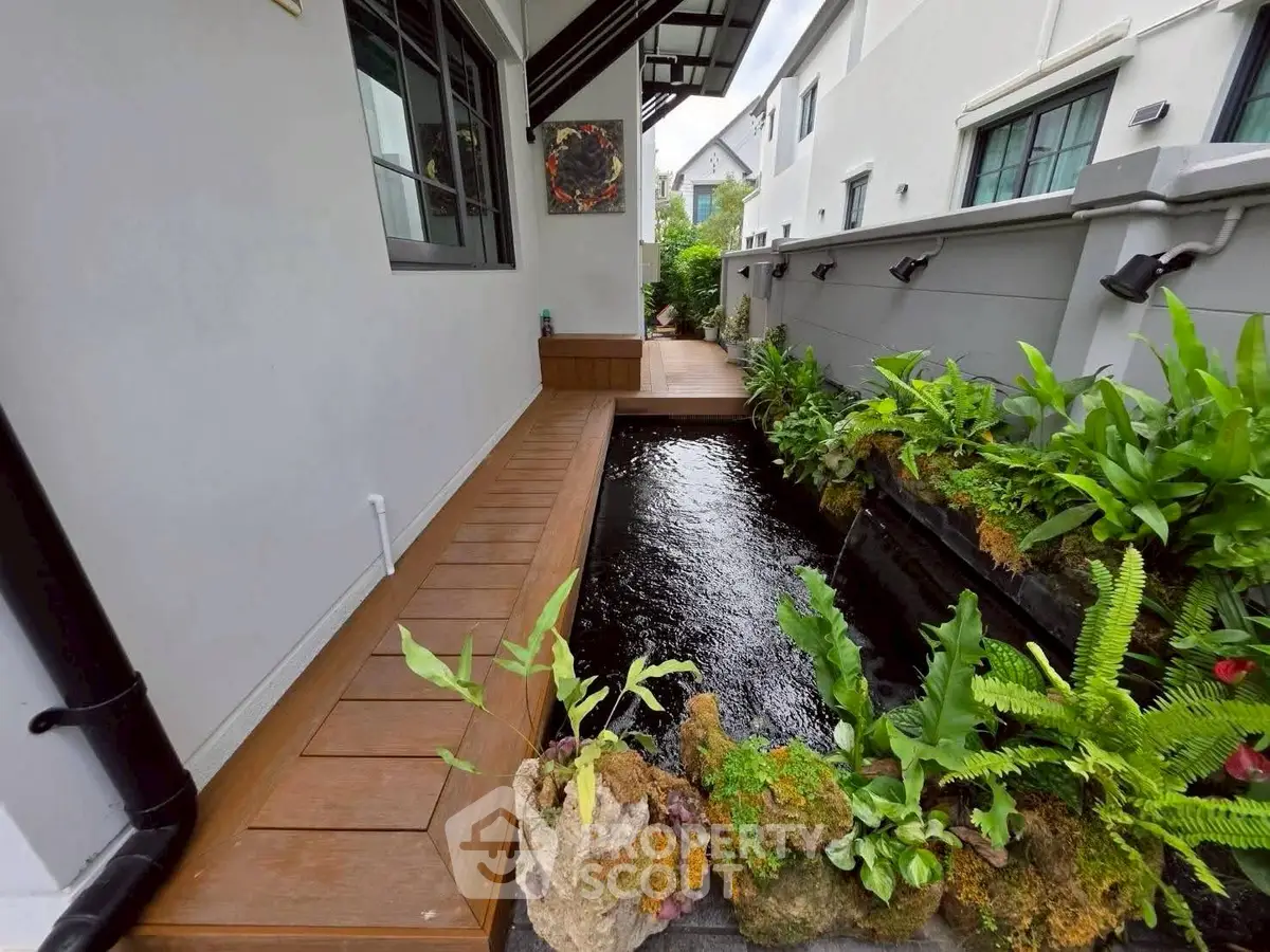 Charming exterior garden with water feature and lush greenery in modern home