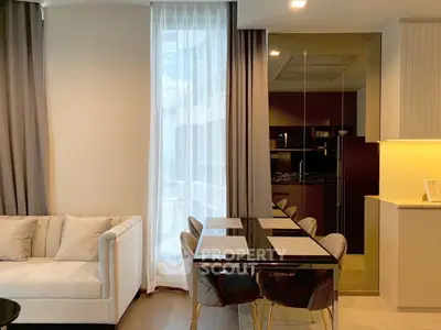 Modern living room with elegant dining area and floor-to-ceiling windows