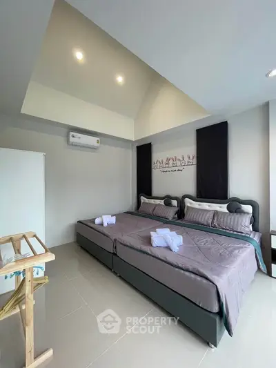 Spacious bedroom with modern decor and twin beds, perfect for comfort and relaxation.