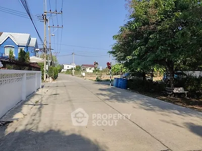 Charming suburban street with houses and lush greenery, ideal for peaceful living.