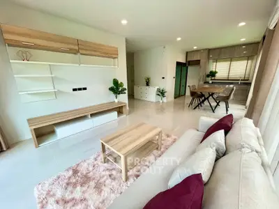 Modern open-plan living room with stylish furniture and cozy decor