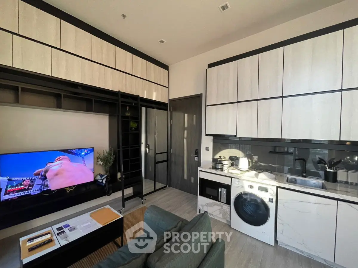 Modern compact living room with integrated kitchen and washing machine
