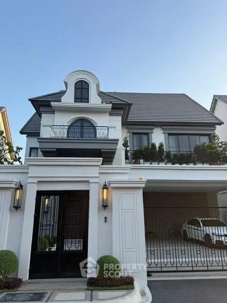 Elegant two-story house with balcony and garage in a serene neighborhood.