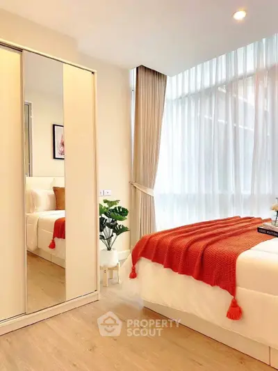 Bright and cozy bedroom with modern decor and large window