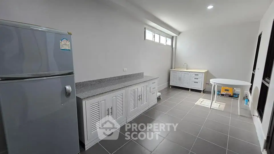Spacious kitchen with modern appliances and ample storage in a sleek design.
