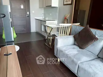 Modern living room with sleek kitchen and stylish decor