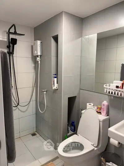 Modern bathroom with sleek shower and toilet in contemporary apartment
