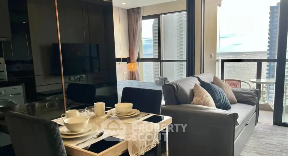 Modern open-plan living room with stunning city view and cozy dining area.