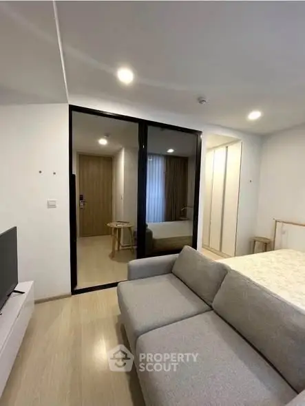 Modern studio apartment with cozy living area and stylish bedroom