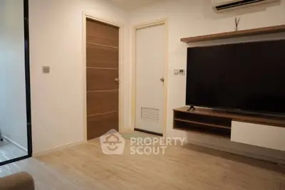 Modern living room with sleek TV setup and wooden flooring