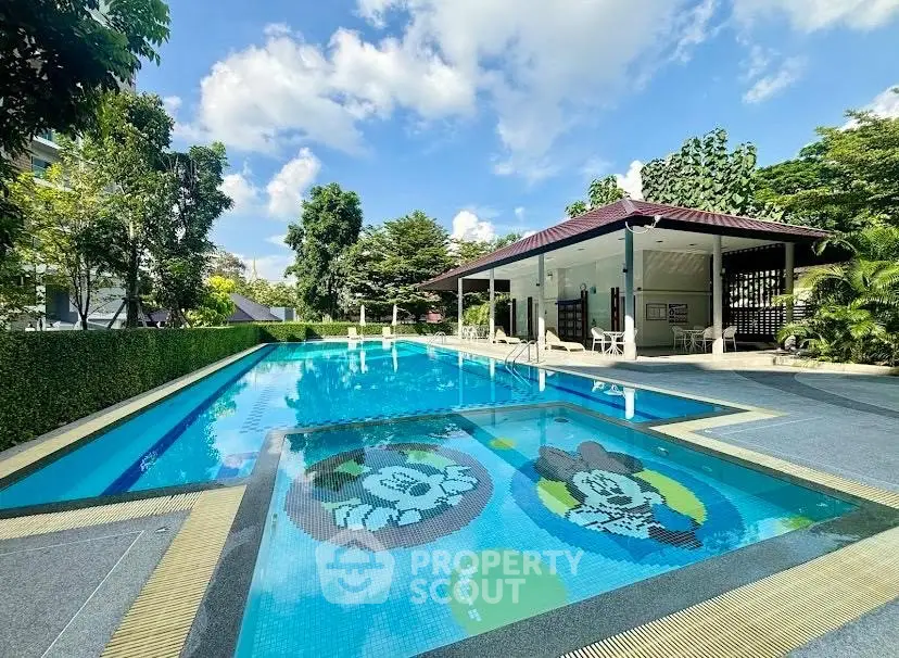 Luxurious outdoor pool with vibrant mosaic design in a serene residential setting.