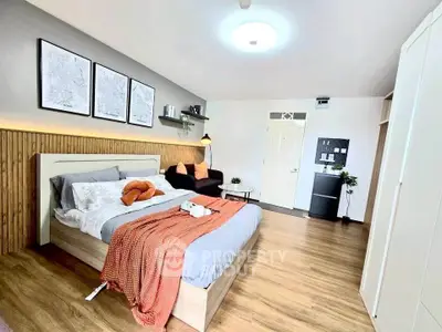 Spacious modern bedroom with stylish decor and wooden flooring