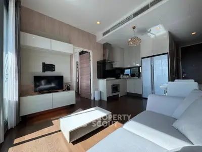 Modern living room with sleek furniture and open kitchen layout in a stylish apartment.