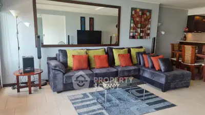 Spacious living room with modern decor and plush seating