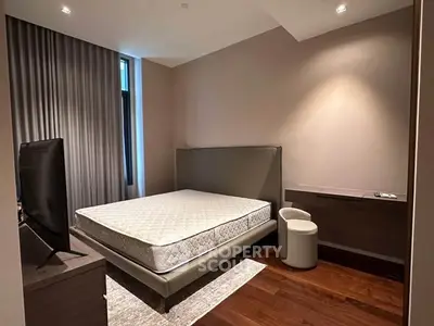 Modern bedroom with sleek design and natural light, featuring a comfortable bed and stylish furnishings.