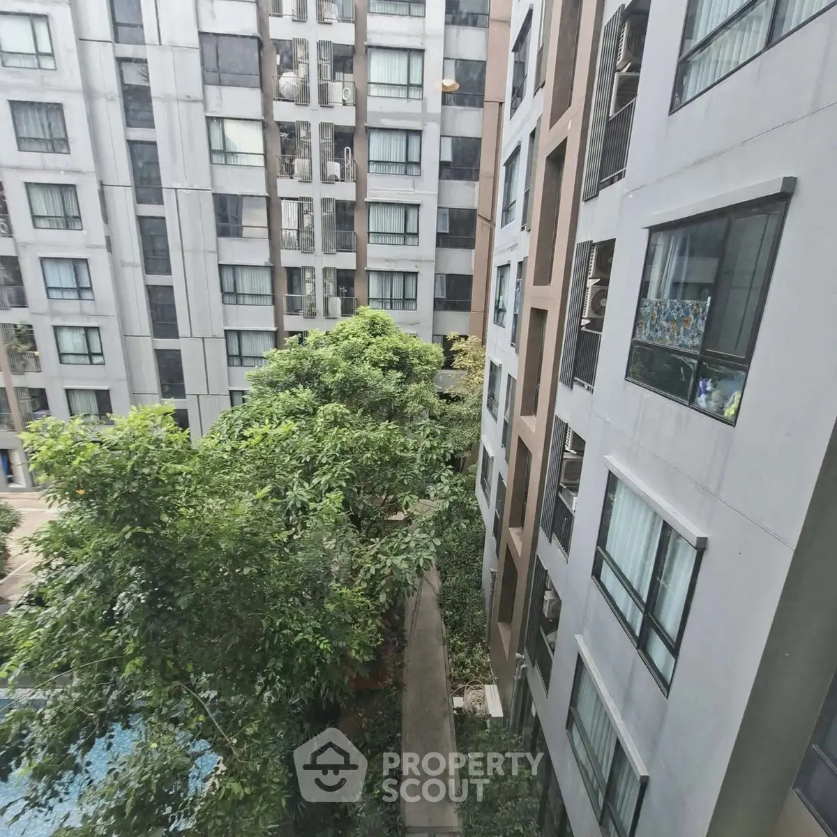 Urban apartment buildings with lush greenery and pool view