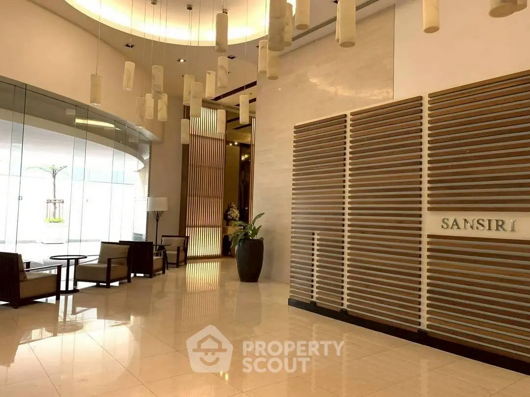 Luxurious building entrance with modern design and elegant lighting, showcasing a sophisticated ambiance.