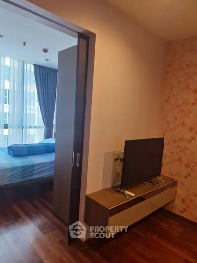 Modern apartment interior with cozy bedroom and sleek TV setup