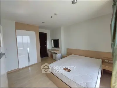 Spacious bedroom with modern design and ample natural light in a stylish apartment.
