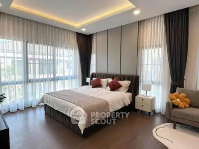 Luxurious bedroom with modern decor, large windows, and elegant lighting in a stylish home.