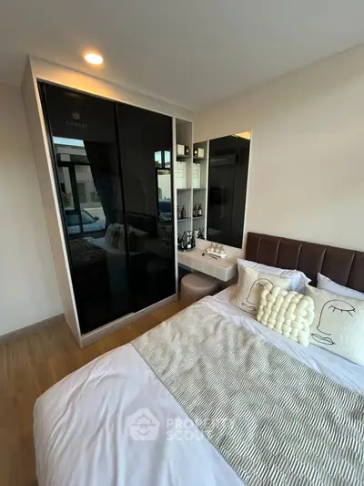 Modern bedroom with stylish decor and mirrored wardrobe