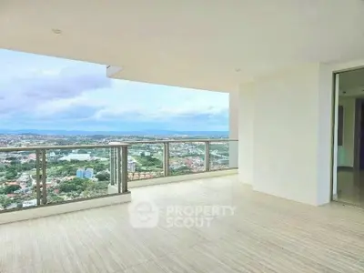 Spacious balcony with stunning panoramic city and ocean views, perfect for relaxation and entertainment.