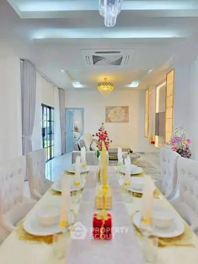 Luxurious open-plan living and dining area with elegant decor and modern lighting.