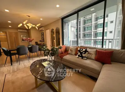 Modern living room with stylish decor and large windows in a high-rise apartment.
