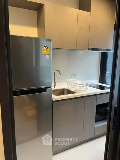 Modern compact kitchen with sleek appliances and stylish cabinetry