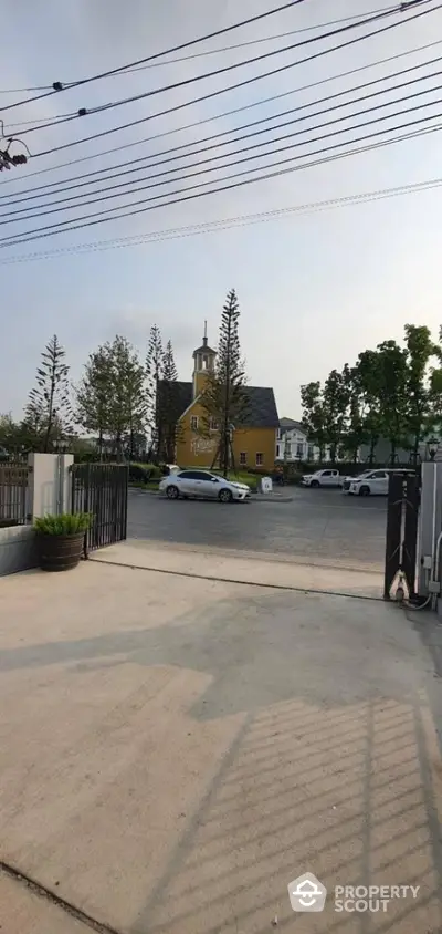 Charming suburban street view with picturesque yellow house and lush greenery