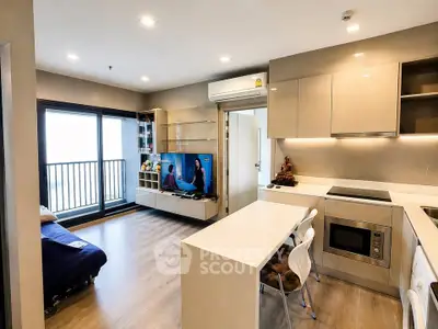 Modern open-layout living room and kitchen with balcony access in a stylish apartment.