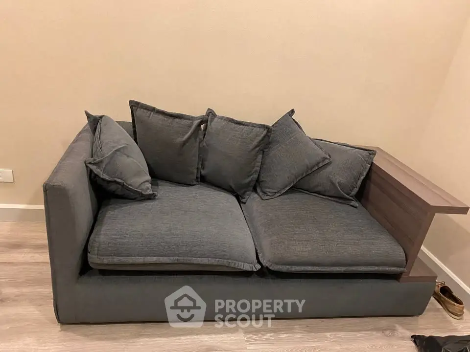 Modern gray sofa with plush cushions in a cozy living room setting.