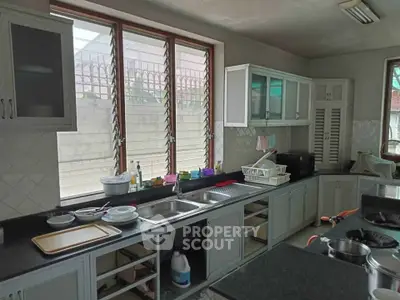 Spacious kitchen with ample counter space and large windows for natural light.