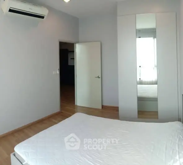 Spacious bedroom with modern air conditioning and ample natural light