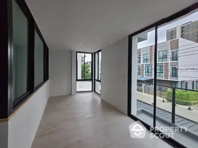 Spacious modern room with large windows and natural light in a contemporary building.