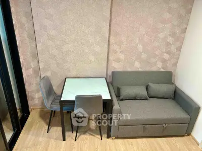 Modern compact living room with stylish sofa and dining table in cozy apartment.