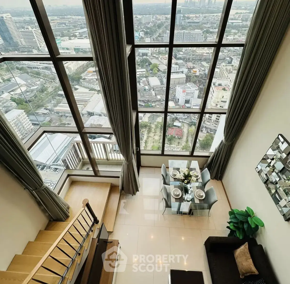 Stunning high-rise apartment with floor-to-ceiling windows offering breathtaking city views and elegant interior design.