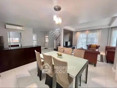 Spacious open-plan living and dining area with modern furnishings and natural light.