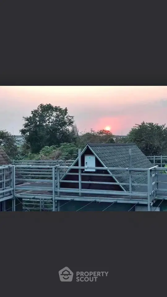 Charming A-frame cabin with sunset view and lush greenery, perfect for serene living.