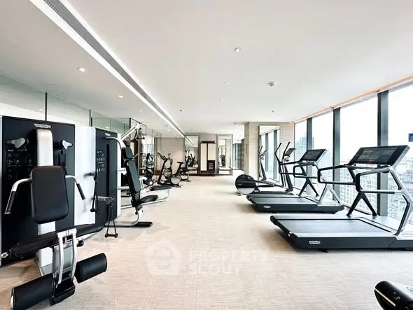 Luxurious high-rise gym with panoramic city views and modern fitness equipment.