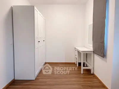 Minimalist study room with white furniture and wooden flooring