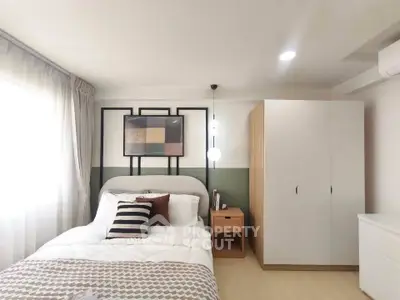 Modern bedroom with stylish decor and ample natural light