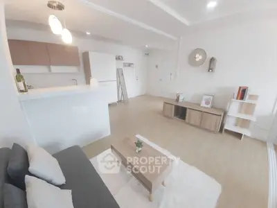 Modern living room with minimalist decor and open kitchen layout