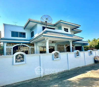 Stunning two-story house with unique architectural design and satellite dish, perfect for modern living.
